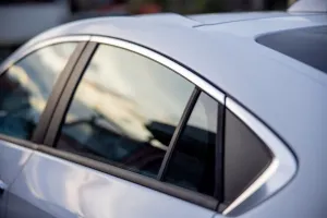 Side and quarter windows on a silver car