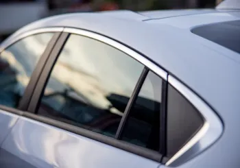 Side and quarter windows on a silver car