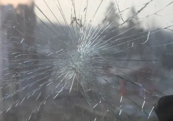 Spiderweb crack spreading across a windshield