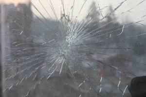 Spiderweb crack spreading across a windshield